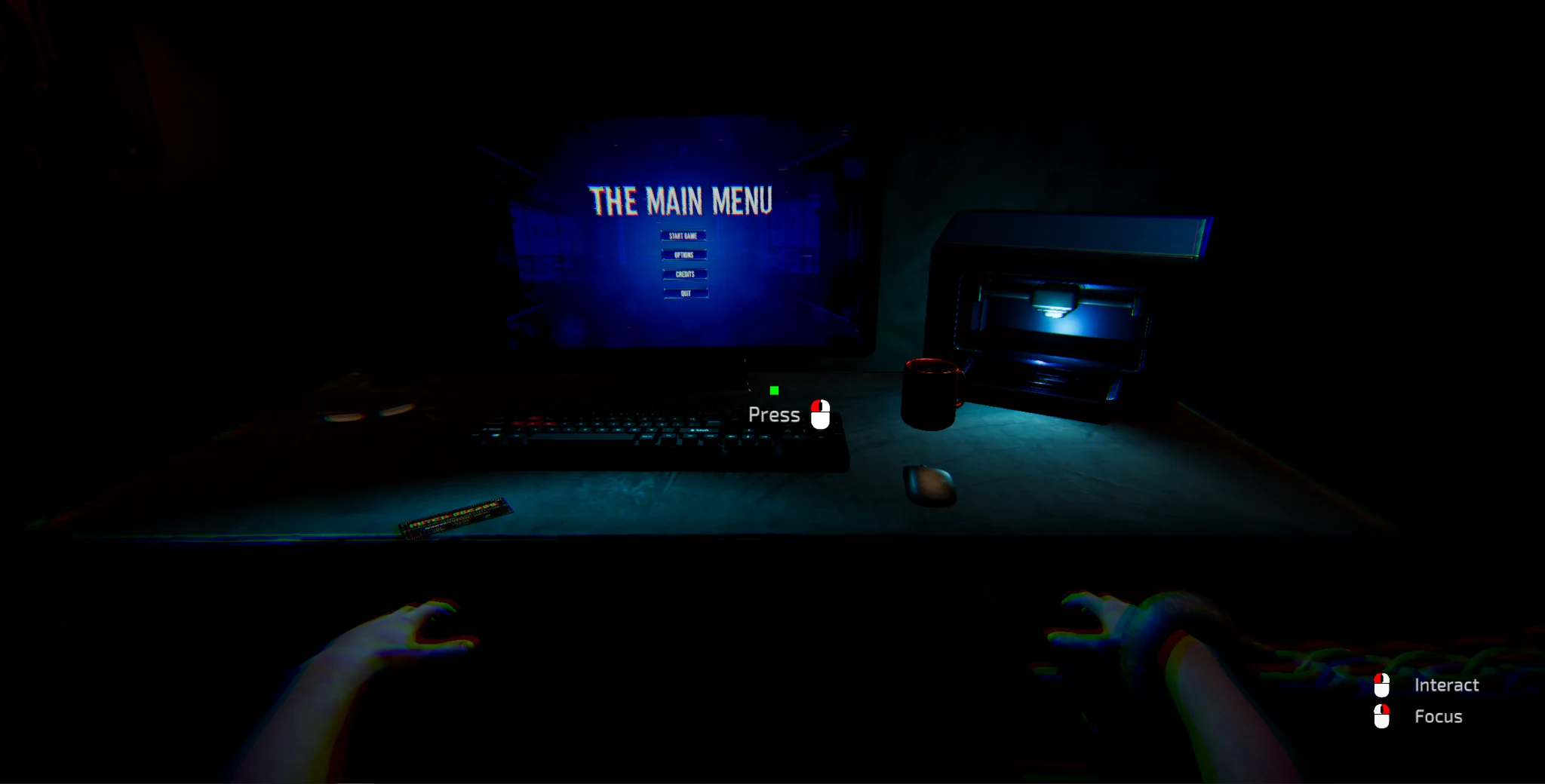 A first-person view from a chair, facing a computer running The Main Menu in a dark room